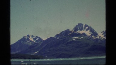 1977: A Blue Colored Mountain Range With River Flowing Beneath It Glacier Bay