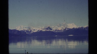 1977: snow capped mountain range surrounding the cold water. GLACIER BAY ALASKA