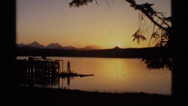 1977: orange sunset fade into the end closing credits. GLACIER BAY ALASKA