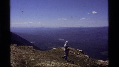 1977: four people walk and sit on the top of a cliff edge SAPPHIRE LAKE MONTANA