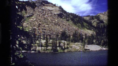 1977: high mountain lake surrounded by rocky exposed hills and some trees
