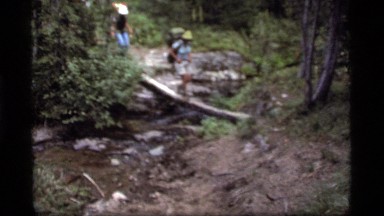1977: hiking over a log in the woods SAPPHIRE LAKE MONTANA