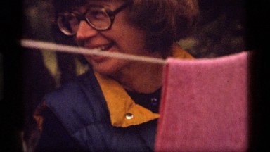 1977: a woman talking while she hangs up clothes SAPPHIRE LAKE MONTANA