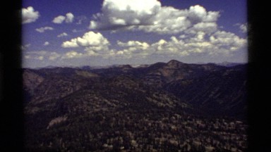 1977: the camera zoom in close on one mountain in a range of mountains SAPPHIRE