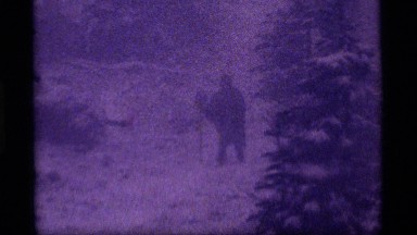 1977: person walking on a trail in the snow with poncho and walking stick
