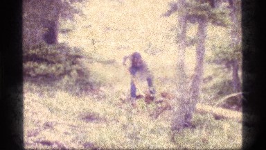 1977: a man shoveling in the woods SAPPHIRE LAKE MONTANA
