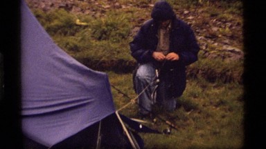 1977: a man tying down a tarp SAPPHIRE LAKE MONTANA