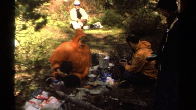 1978: people in rain gear sitting near an outdoor stove LAKE TAHOE CALIFORNIA