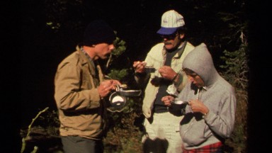 1978: three people outdoors eating out of a sierra cup LAKE TAHOE CALIFORNIA