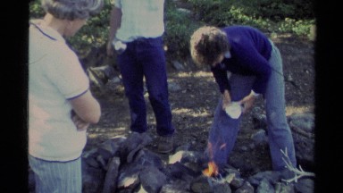 1978: friend trying to lite campfire in blue jeans LAKE TAHOE CALIFORNIA
