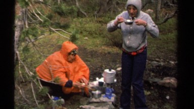 1978: two friends having fun and enjoying their meal together in the wilderness