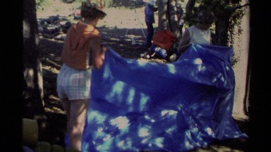 1978: three ladies work together to pitch a tarp tent LAKE TAHOE CALIFORNIA