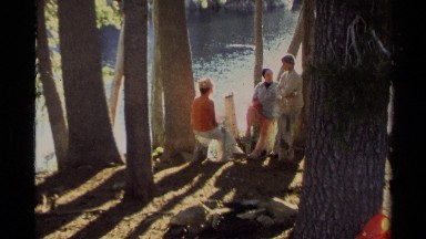1978: group of people sitting together near a body of water LAKE TAHOE
