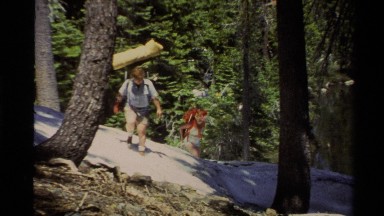 1978: two people are on a hike up a hill in a dense forest LAKE TAHOE CALIFORNIA