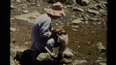 1978: a man with a cap is sitting alone and eating something LAKE TAHOE