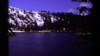 1978: a lake is surrounded by snowy hills and pine trees LAKE TAHOE CALIFORNIA