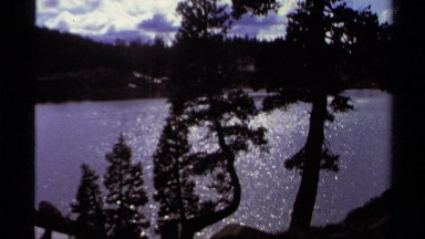 1978: A Panoramic View of Lake Tahoe Surrounded by Trees and Mountains