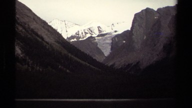 1979: snow covers large, gray mountains in a frozen arctic climate