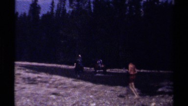 1979: people riding horses through water while others observe BRITISH COLUMBIA