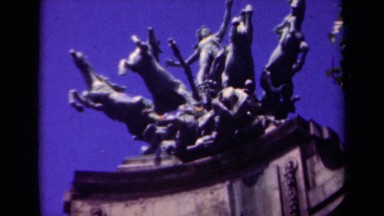 1939: an intricate, detailed, bronze statue sits high atop a perch PARIS FRANCE