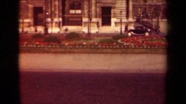 1939: black car driving down city street with view of flowers PARIS FRANCE