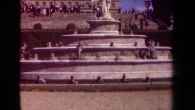 1939: a woman posing with a man wearing an army uniform in front of fountain