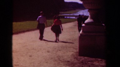 1939: pedestrians walk down a large dirt pathway toward a waterway