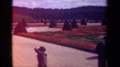 1939: a group of tourists stand around in a sprawling garden PARIS FRANCE