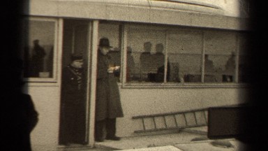 1947: men, women, children, and soldiers look at view from elevated terrace