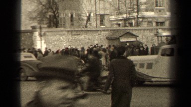 1947: pedestrians carefully cross a busy intersection as cars drive by PARIS