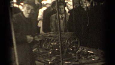 1947: a man uses a file to sand and shave parts of a machine PARIS FRANCE
