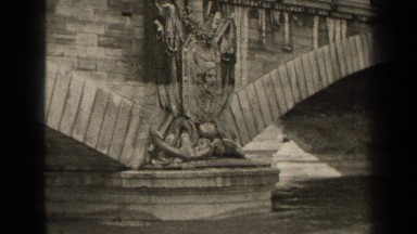 1947: Beautiful Arched Bridge Spanning River in Paris France