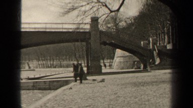 1947: Two People Stand Near River Overpass as Man Walks Toward Them