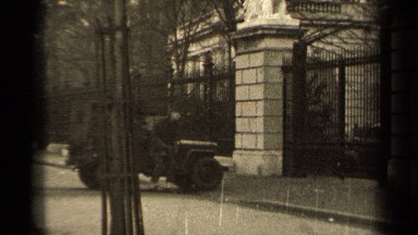 1947: person outside in dark clothing near a large building PARIS FRANCE
