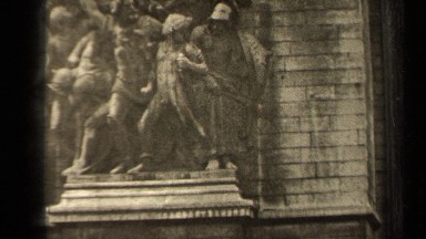 1947: ornate carving of people and angels outside of a brick building PARIS