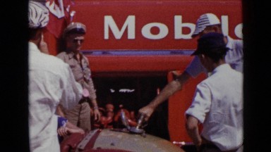 1952: man in uniform adjusts his hat while others stand and sit around him