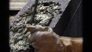 1953: he is hurriedly moving rebar around in mix to assure there is no air
