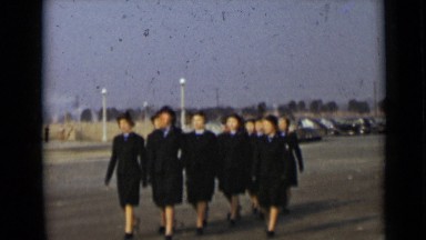 1947: girls wear same type of dresses and march fast at day time NEW YORK