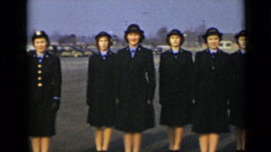 1947: twelve white women in blue uniforms standing at attention outside NEW YORK