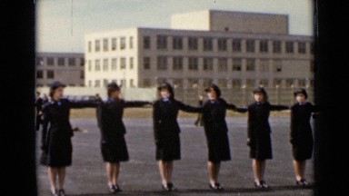 1947: military women in dark uniforms stand in formation one arm length away