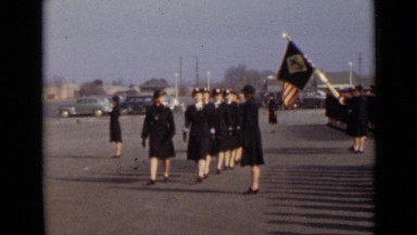 1947: some ladies are walking uniformly, head turn direction of left side