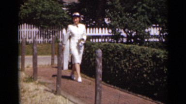 1947: the woman was walking in pathway NEW YORK