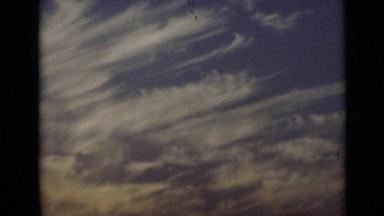 1947: woman playing with waves on shore of sea under cloudy sky NEW YORK