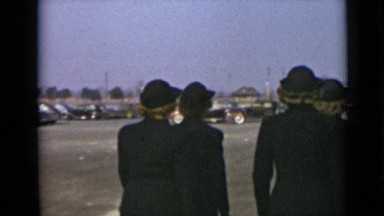 1947: nine women are doing march past in uniformly including costumes at day
