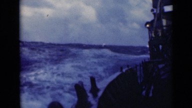 1947: an enormous ship rolling,pitching and sailing on strong waves of ocean