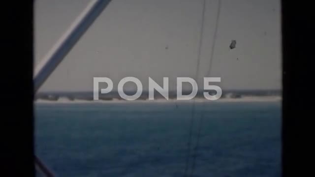 1947: Cargo Ship Carrying Crates Battles Treacherous Seas During Day.