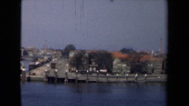 1946: shipping port with boats, factories and city in background. NETHERLANDS