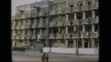 1946: huge buildings and people are walking on street SUEZ CANAL EGYPT