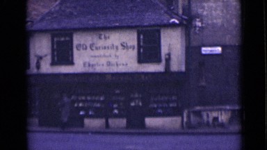 1946: Man Entering Shop in London Street Scene