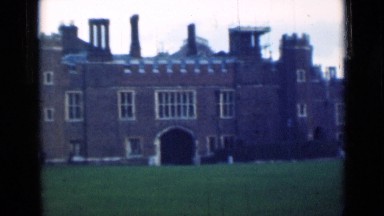 1946: Couple Walking on Road Beside Lawn in London